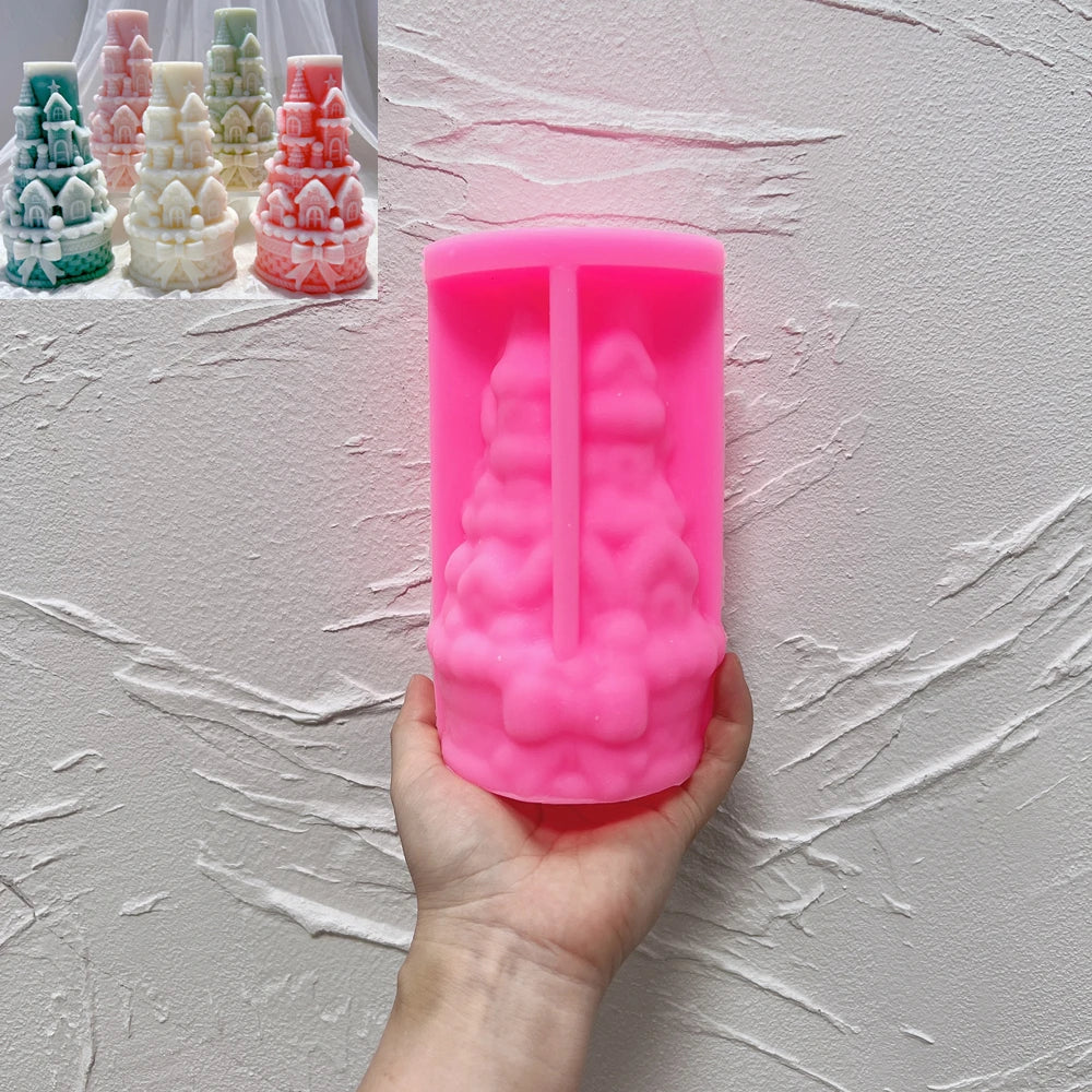 Pink silicone bow castle tower mold held beneath finished examples