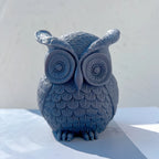 Single blue owl candle viewed from the front