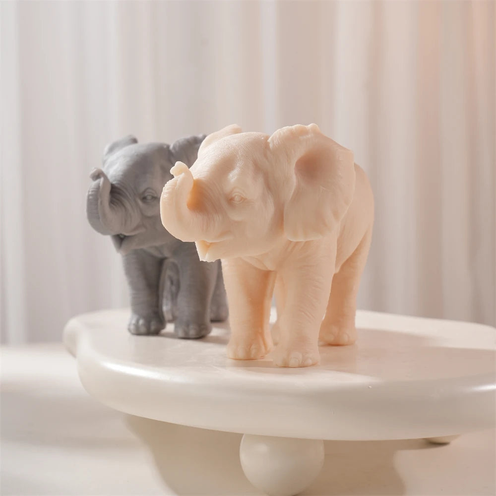 Angled view of elephant figures with curled trunks and skin folds