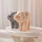 Angled view of elephant figures with curled trunks and skin folds