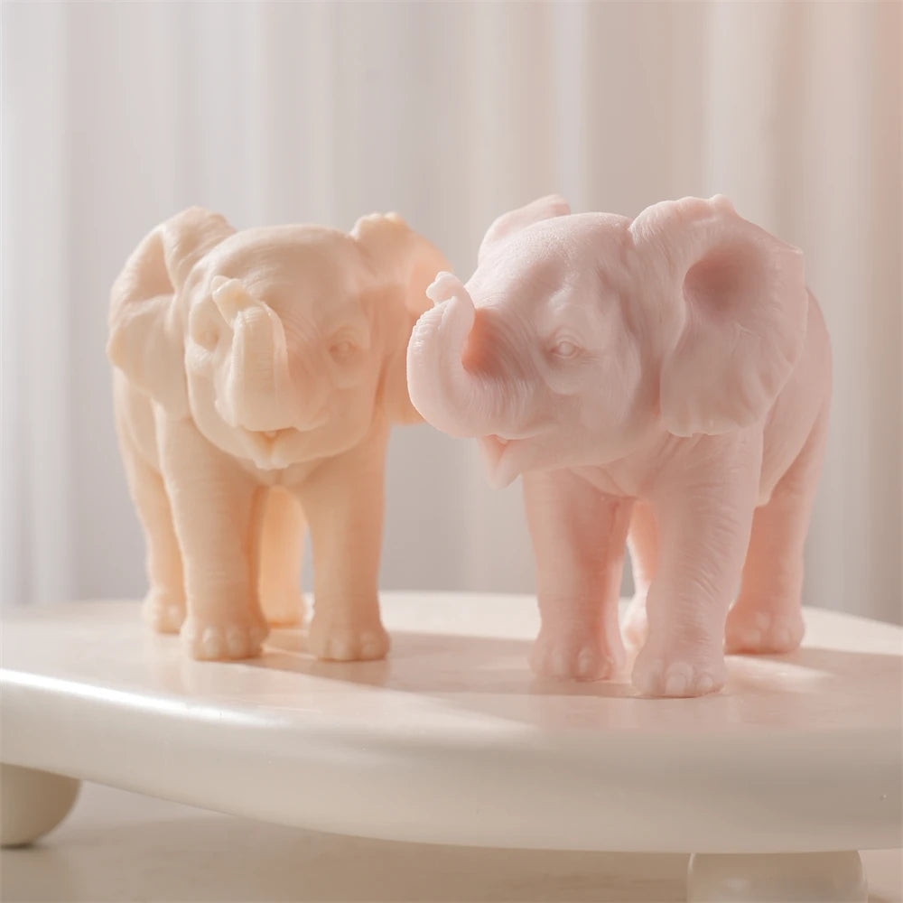 Peach and pink raised-trunk elephants on a display surface