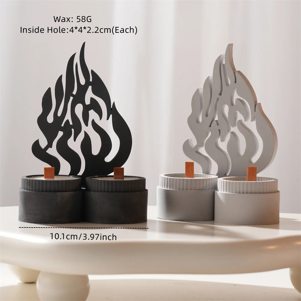 Black and silver flame motif castings standing on paired round bases