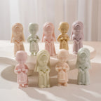 Girl and lantern-boy figures grouped on a stand