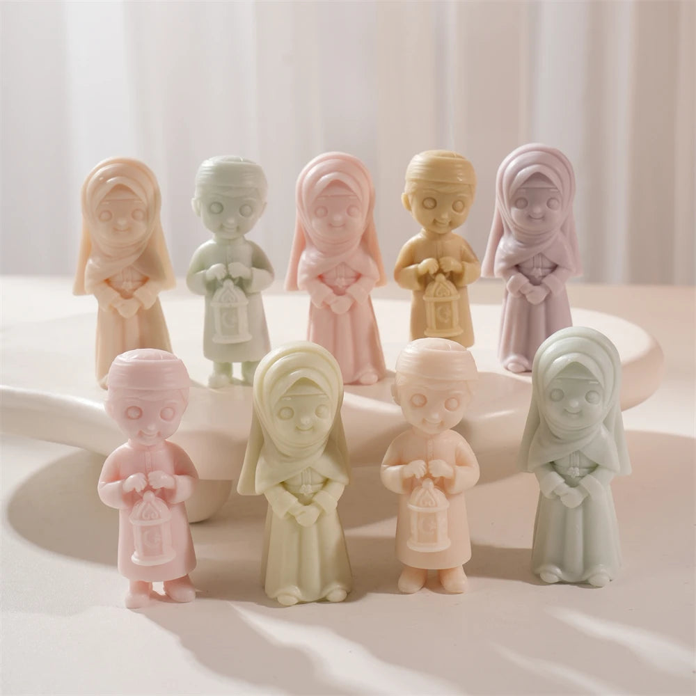 Girl and lantern-boy figures grouped on a stand