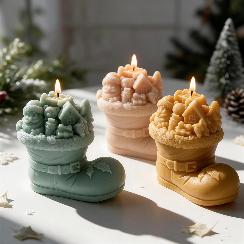 Three Christmas cottage boot castings with miniature figures and trees