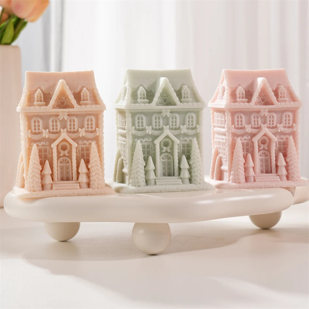 Tall gingerbread house candles with upper windows and ornate doors