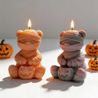 Bandage-wrapped bear candle pair with jack-o'-lanterns