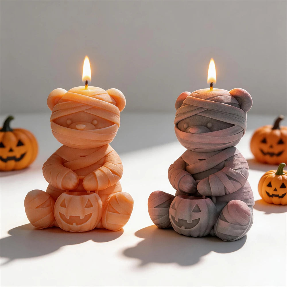 Bandage-wrapped bear candle pair with jack-o'-lanterns