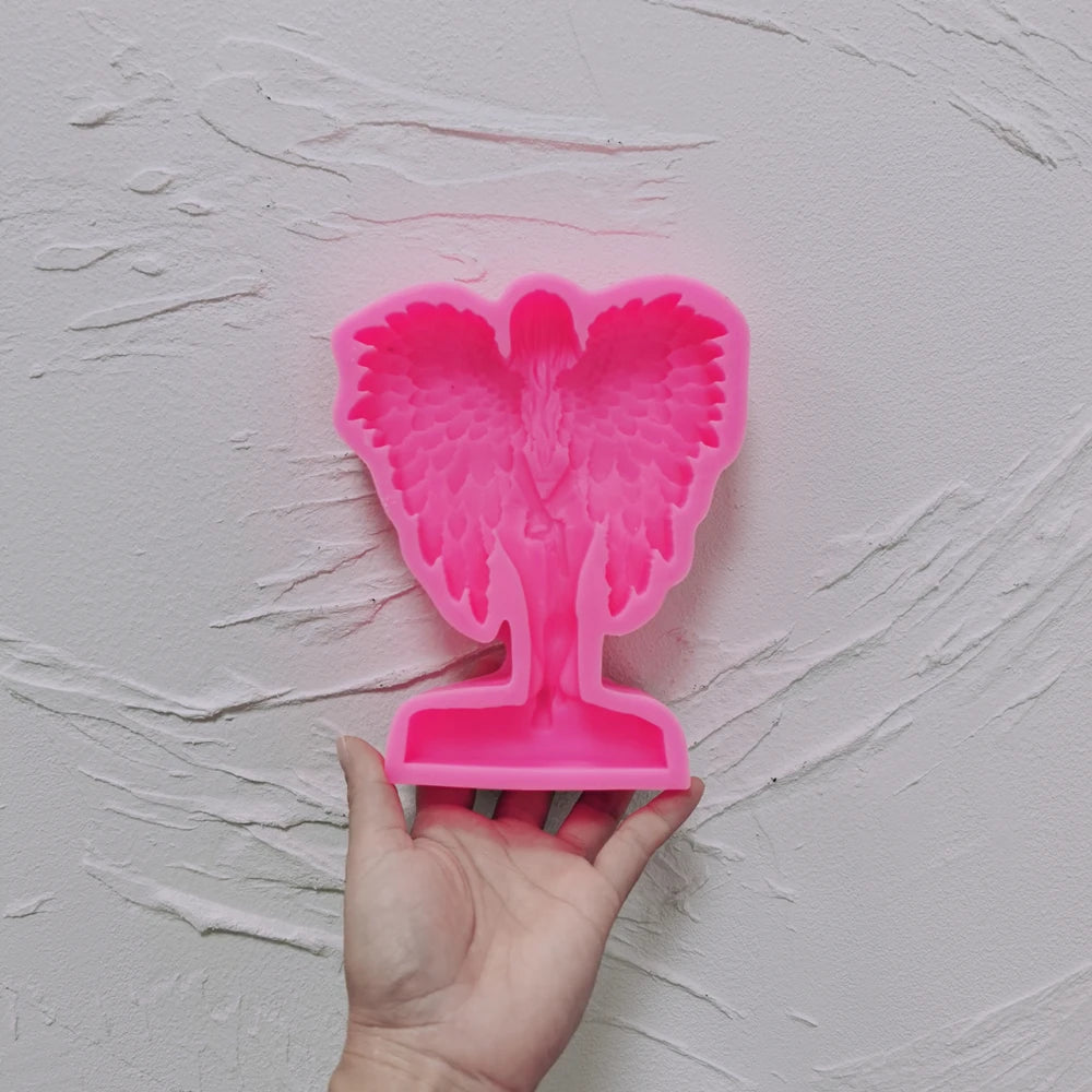 Pink silicone winged figure relief mold with integrated base cavity