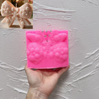 Pink silicone mold for ornate textured holiday bow casting