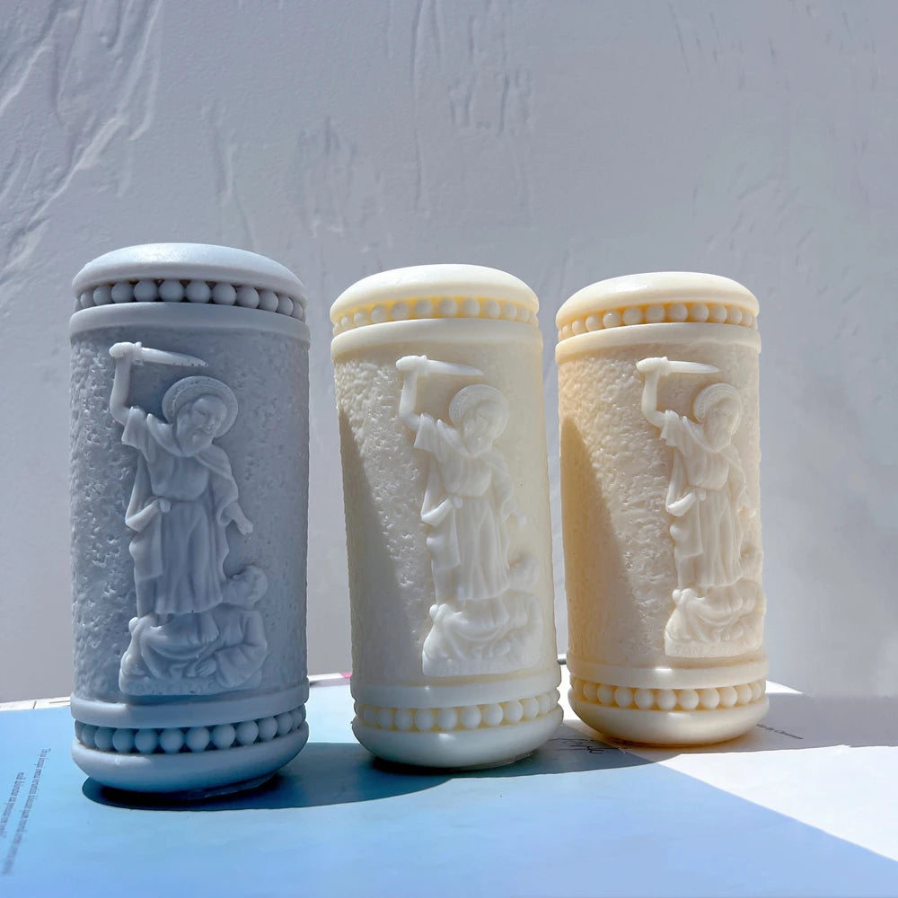 Three textured pillars with robed sword-bearing figure relief
