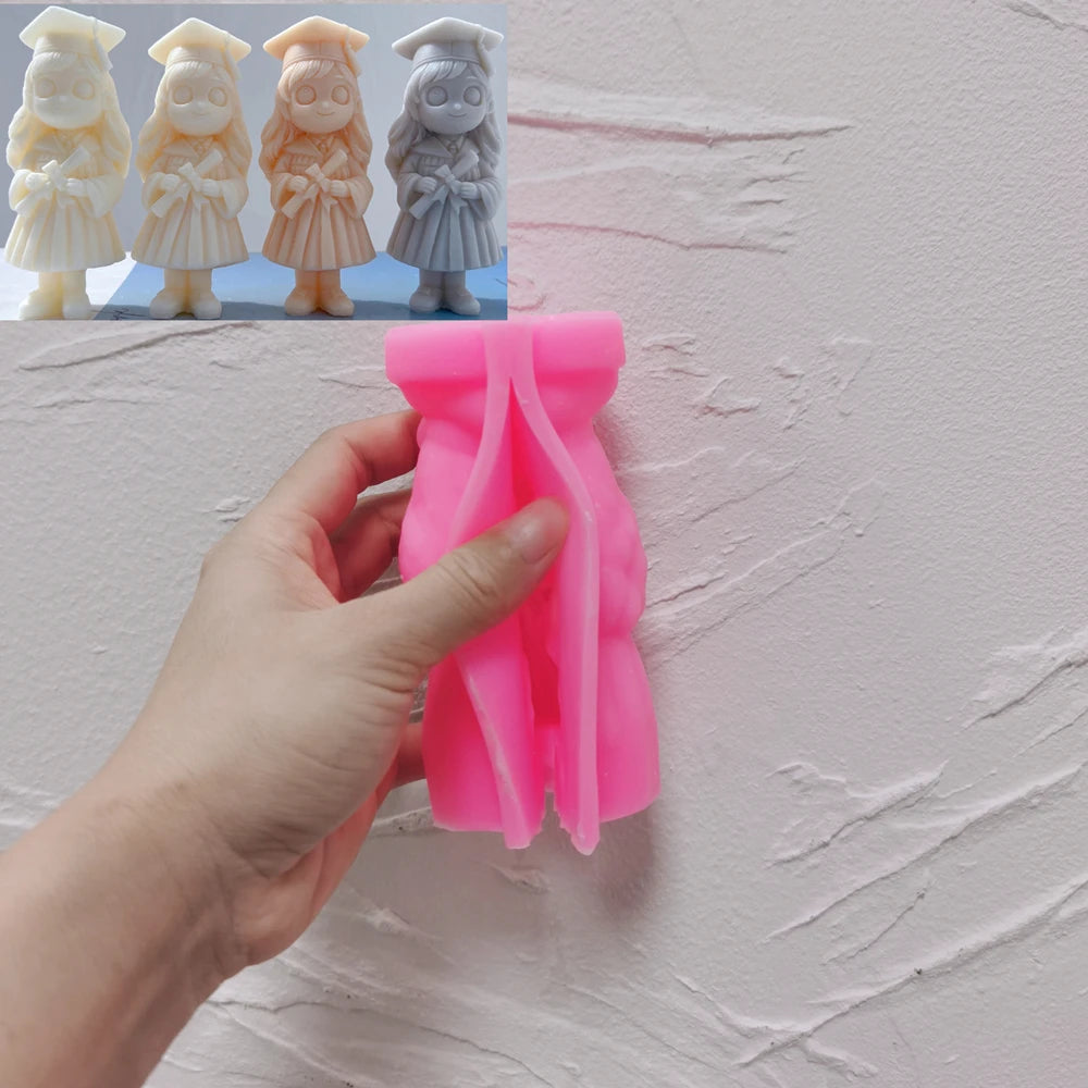 Pink girl graduate silicone mold held in one hand