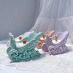 Green and lavender Christmas sleigh vessels with wax fills