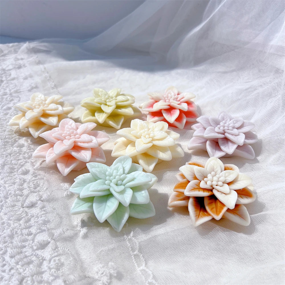Floral wax castings arranged on textured white fabric