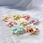 Floral wax castings arranged on textured white fabric