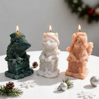 Three animal chimney candles in green, cream and peach