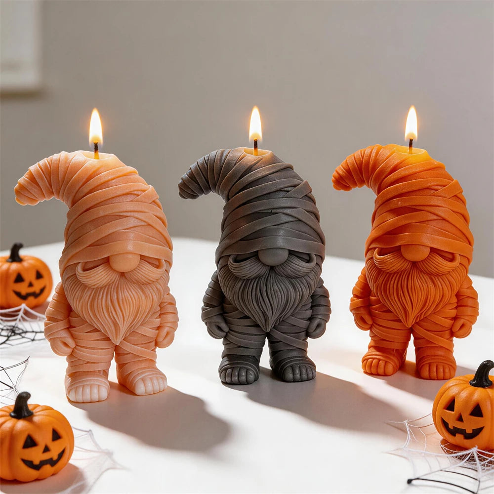 Three mummy gnome candle samples with bandaged hats and sculpted beards