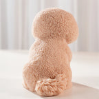 Rear view of the fluffy puppy casting with its curled tail