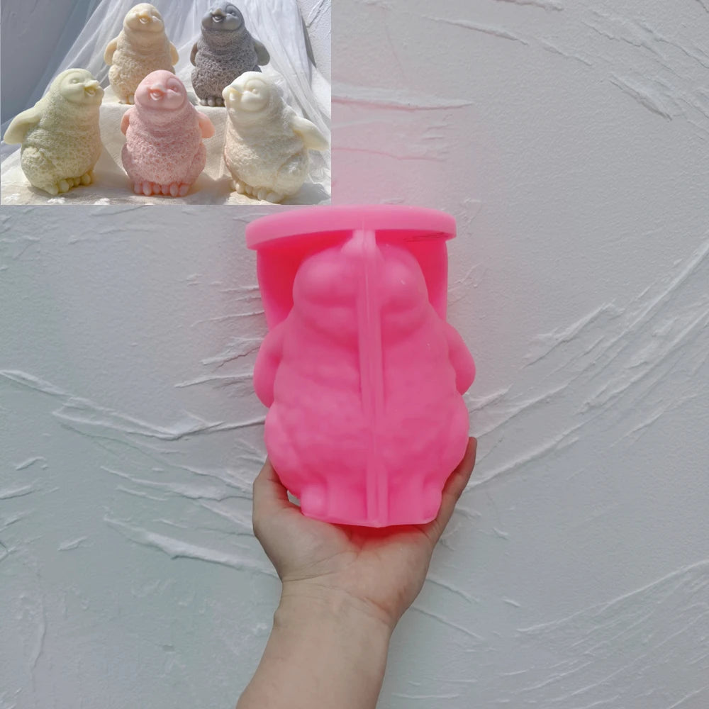 Pink silicone penguin mold held in one hand