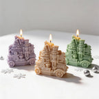 Purple yellow and green Christmas train candles with nutcrackers and trees