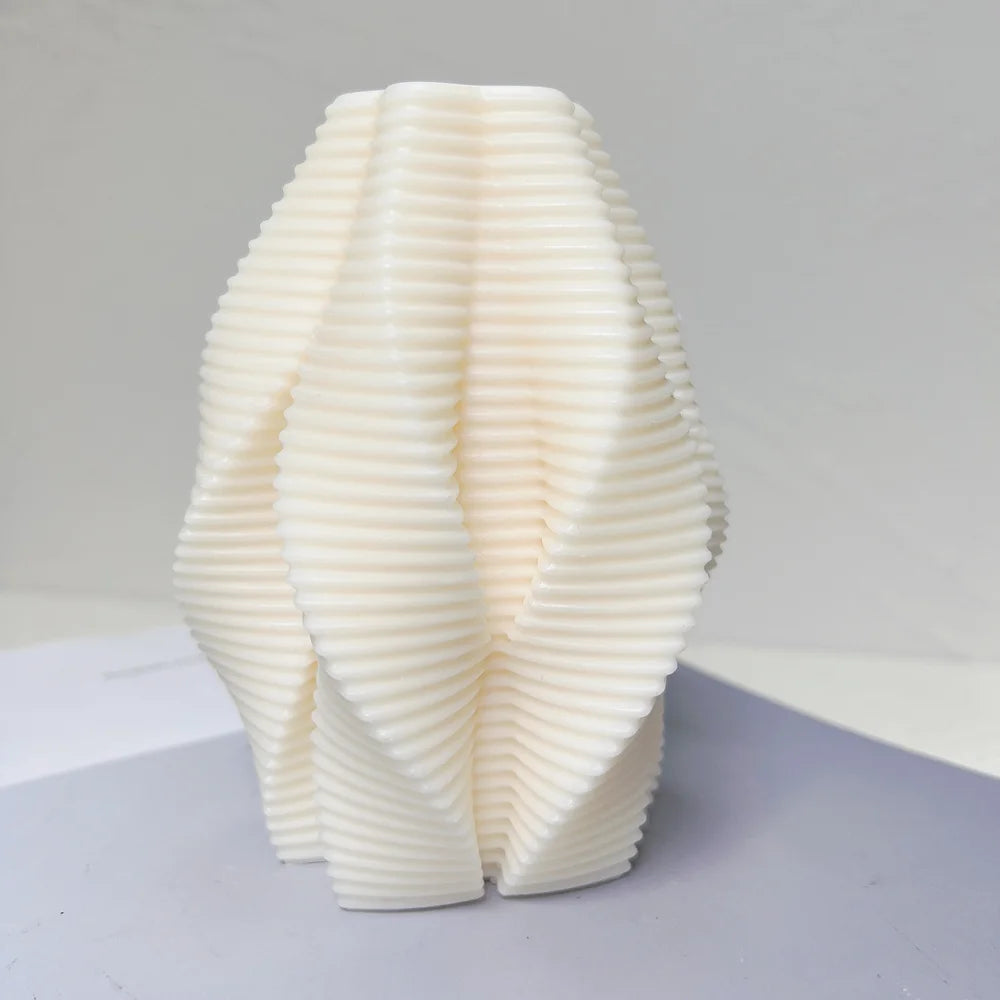 Angled view of fine horizontal ribbing across folded candle contours