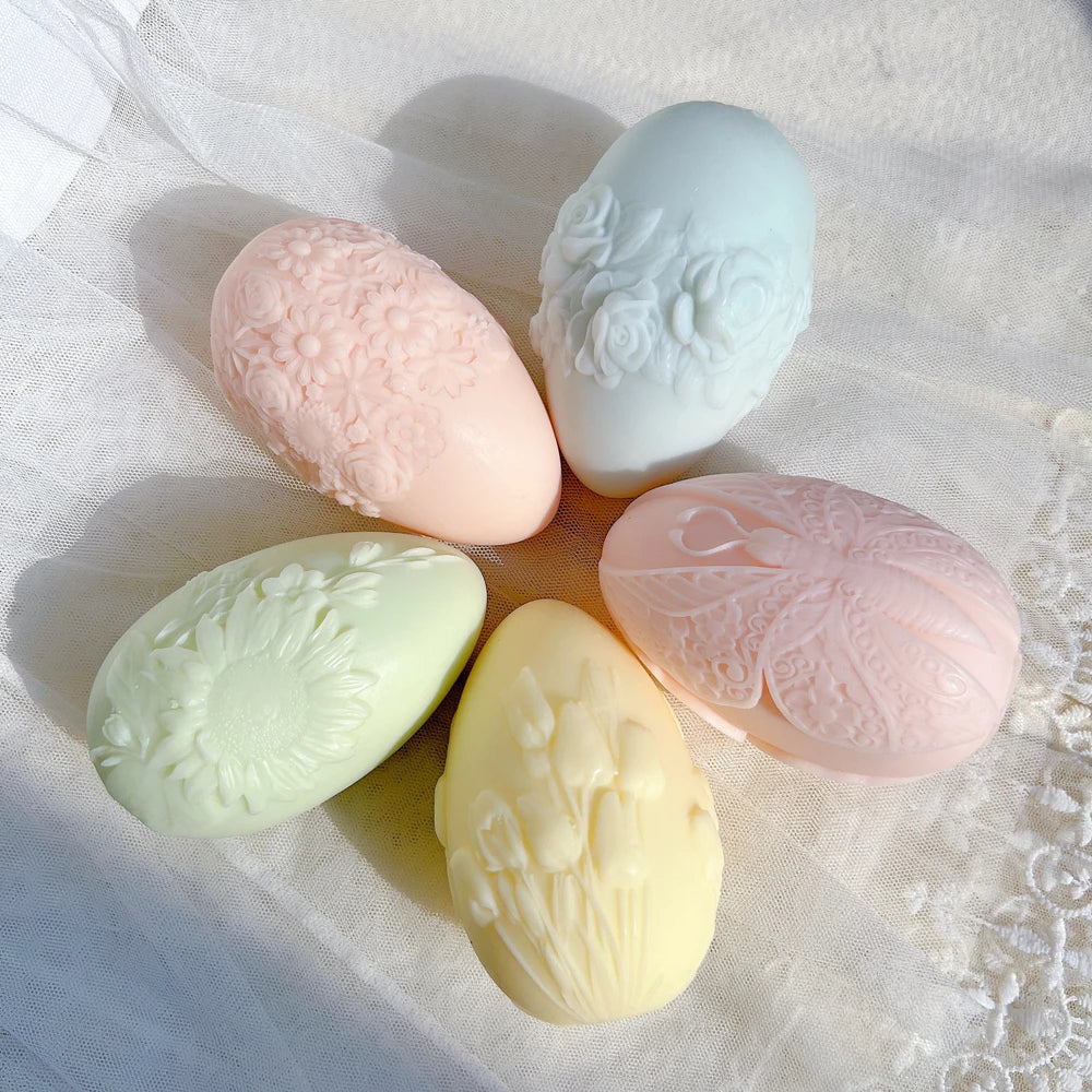 Five egg designs arranged with their relief faces visible