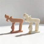 Two Chai sculptures showing smooth outer forms and inset textures