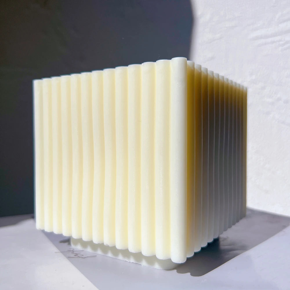 Angled view of ribbed square candle sides