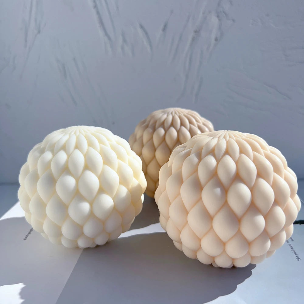 Three scale-covered candle balls grouped in sunlight