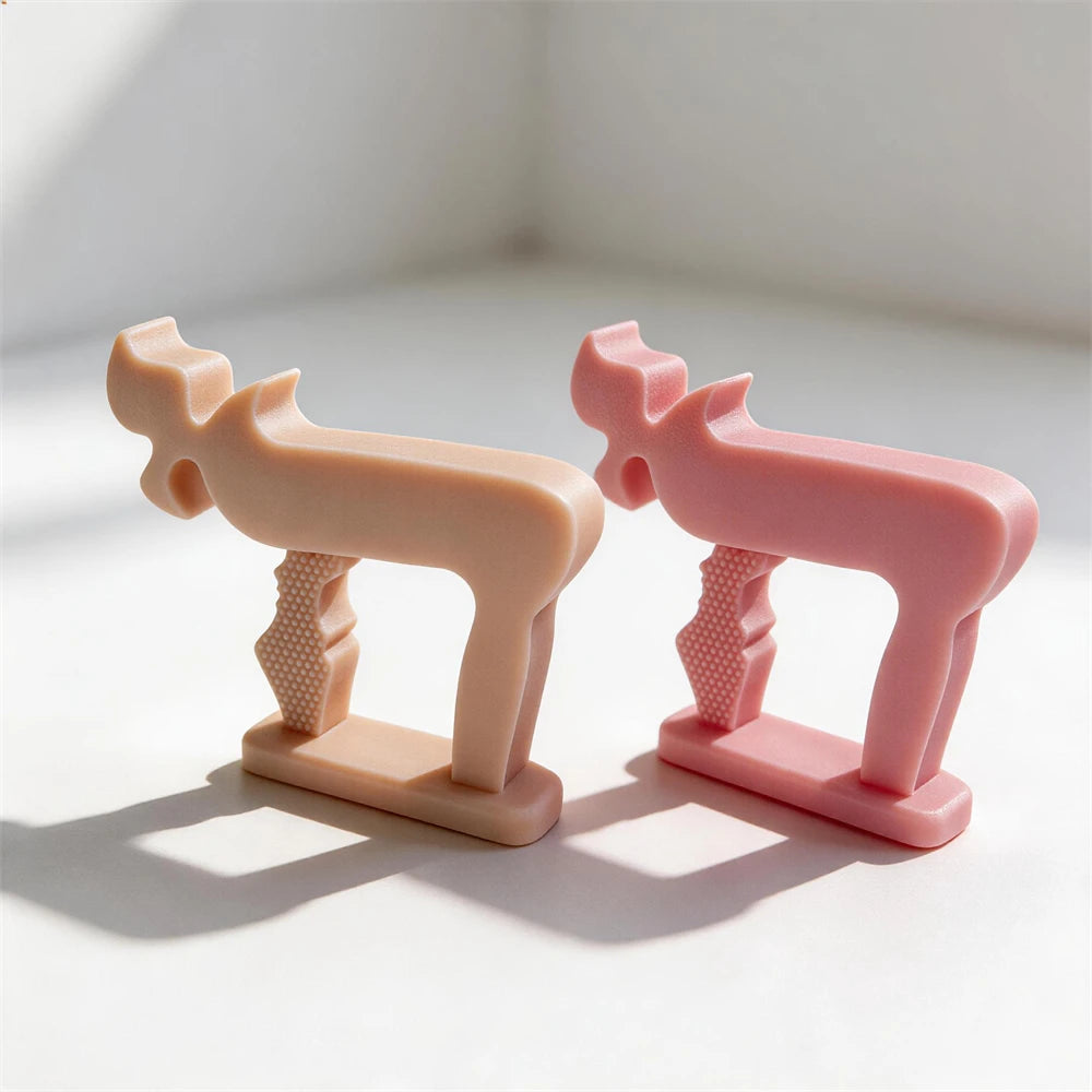 Peach and pink symbol sculptures viewed at an angle