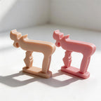 Peach and pink symbol sculptures viewed at an angle