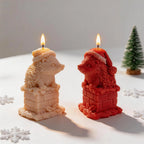 Cream and red hedgehog candles beside holiday decorations