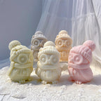 Winter owl candle group with a pink owl showing its feathered side