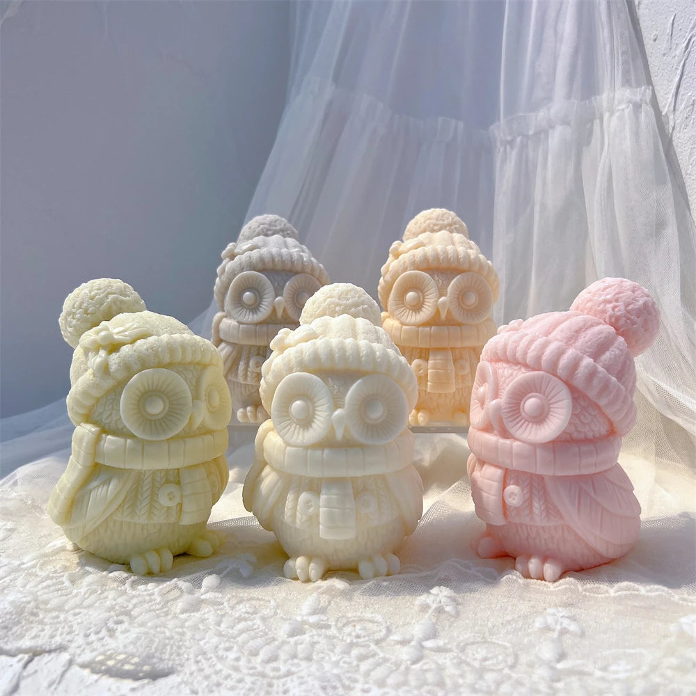 Winter owl candle group with a pink owl showing its feathered side