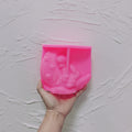 Pink silicone angel crescent moon mold held in a hand