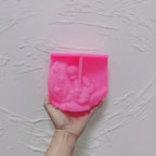 Pink silicone angel crescent moon mold held in a hand