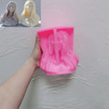 Pink flowing-hair woman bust silicone mold held in one hand