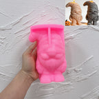 Pink silicone mummy gnome mold held in a hand