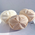 Three textured leaf-petal cube castings arranged together