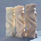 Front view of cream and gray twisting wave pillars