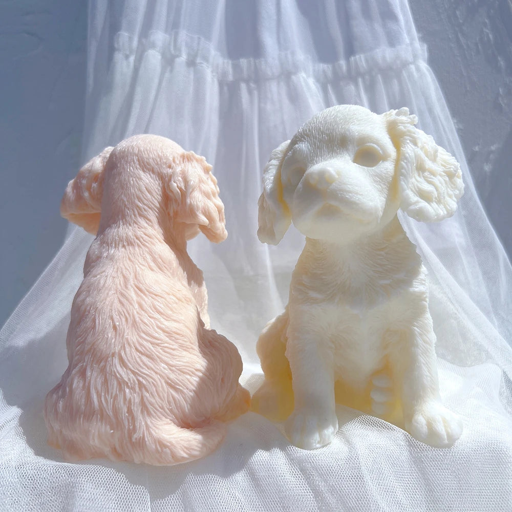 Rear and front views of seated puppy castings with curled tails