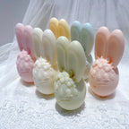 Side view of long-eared bunny egg candles and flower crown details