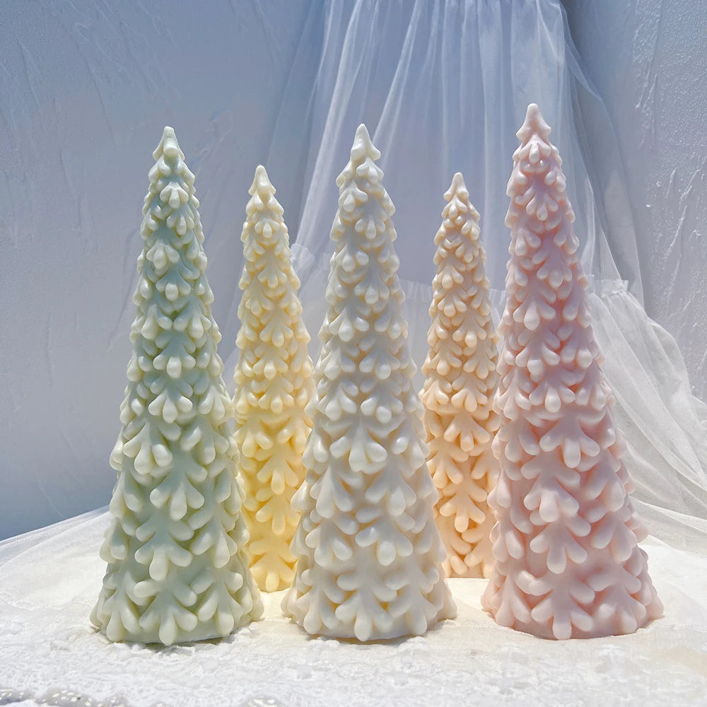 Pastel green cream and pink sculpted Christmas tree candles grouped together