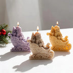 Angled view of ornate sleigh candles and sculpted Santa figures