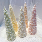 Standing pastel pine tree candles with overlapping textured branches