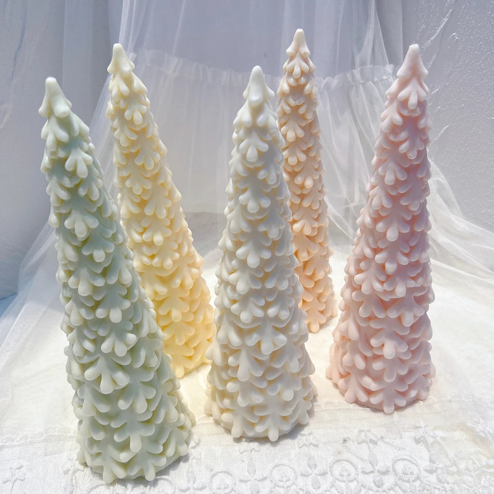Standing pastel pine tree candles with overlapping textured branches