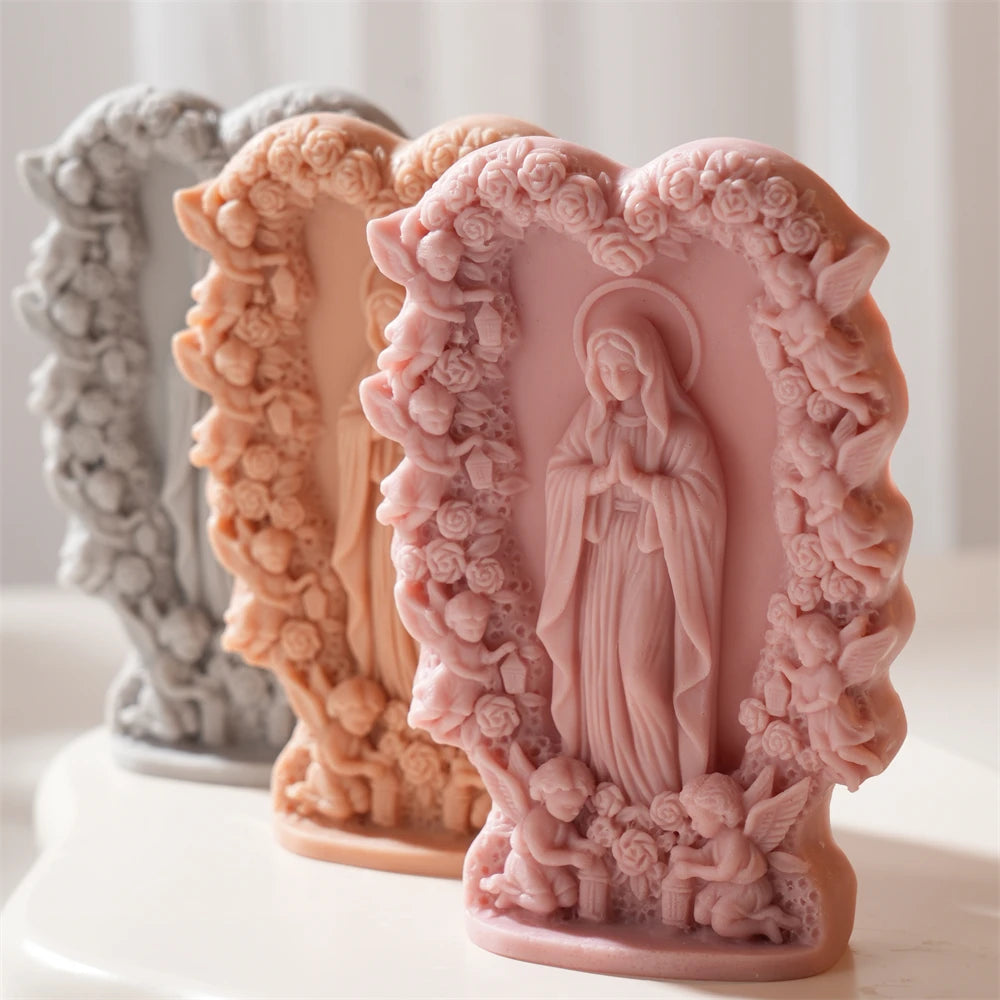 Pink Virgin Mary relief beside peach and gray examples