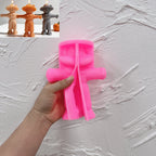 Pink silicone scarecrow mold held open showing the outstretched arm shape