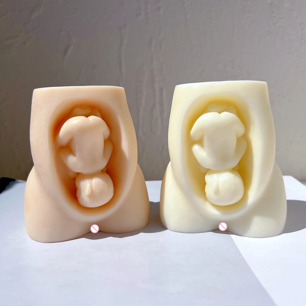 Pregnancy torso castings with curled baby motifs in recessed fronts