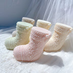 Angled view of cream mint and pink stocking figures